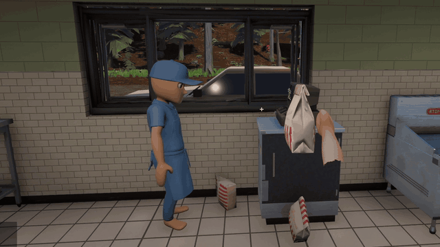 A co-op partner in blue scrubs grabs a striped Grinner's take-out bag at the drive-thru register, bags all over the floor